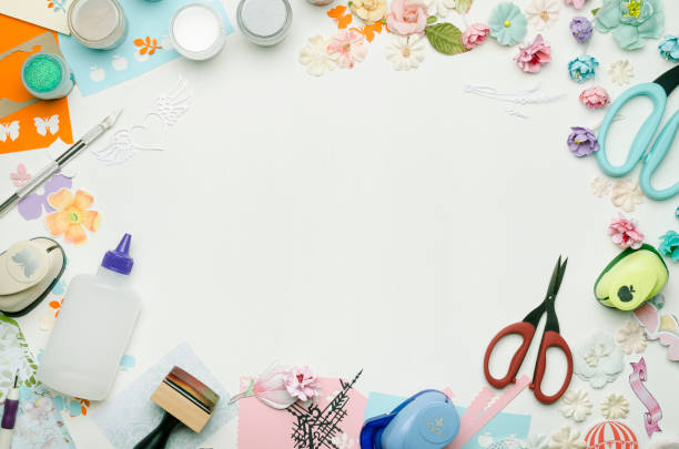 istock Empty white space in the center surrounded by paper flowers, multi-colored paper and scrapbooking materials 1005246310
