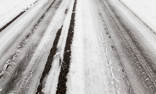 track on the road covered with snow in the winter season, Photo taken close up