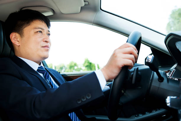 istock Handsome businessman driving his car 1005254346