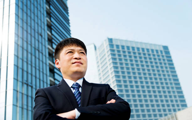 istock Businessman standing in front of office building 1005254646