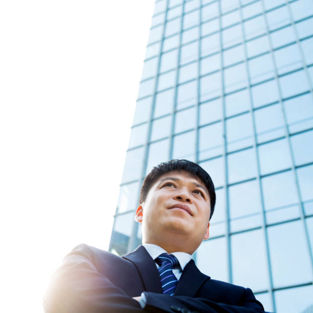 istock Businessman standing in front of office building 1005254664