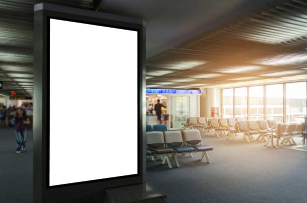 istock mock up of vertical blank advertising billboard or light box showcase with waiting cone at airport, copy space for your text message or media content, advertisement, commercial and marketing concept 1005257396