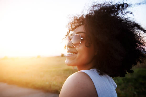 istock African woman with sunglasses having fun 1005259600