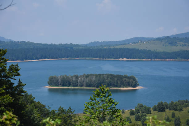 istock Beautiful cloudy sky over the mountain lake 1005279586