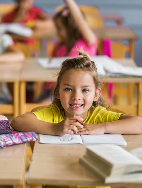 istock Happy schoolgirl during a class in the classroom. 1005287816