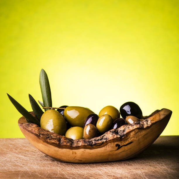 istock assorted olives in the rustic wooden bowl 1005291602