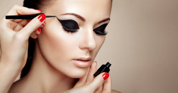 istock Makeup artist applies eyeshadow 1005294284