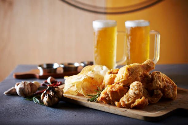 Fried chicken, potato chips and beer stock photo