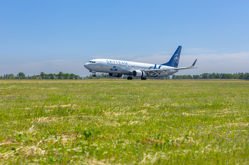 SkyTeam air vehicle is touching down at Boryspil airport, Ukraine. SkyTeam is an airline alliance. Founded in June 2000. It flies to more than 1,000 destinations in 178 countries and operates some 15,700 daily flights with a combined fleet of over 4,400 aircraft, including associate carriers.