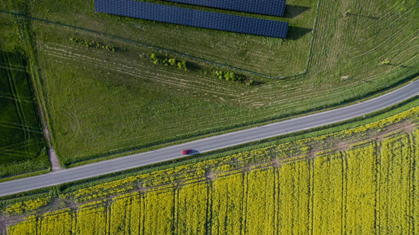 istock Rape field, street, car, solar power plant 1005315916