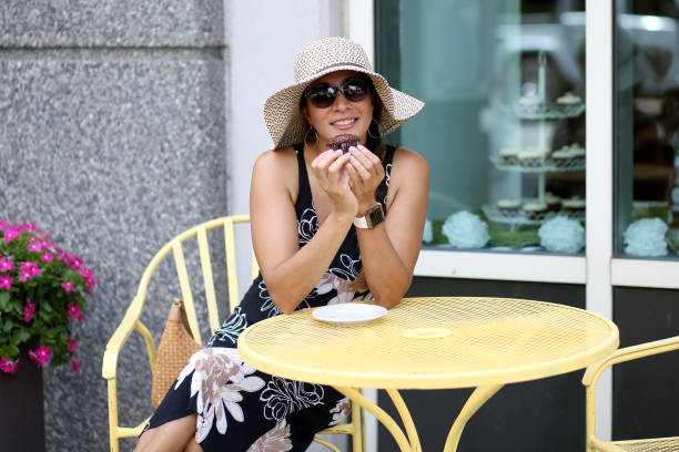 istock Woman eating a cupcake 1005324300
