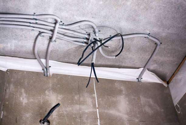 istock Electrical junction box with plastic corrugated pipes with electric cables in the process of installation on the ceiling. 1005331420