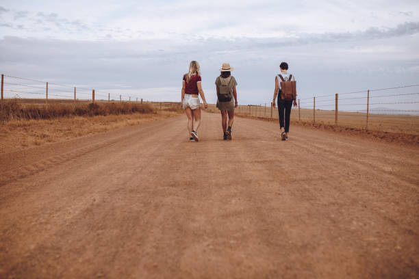 istock Women walking down the country road 1005334480