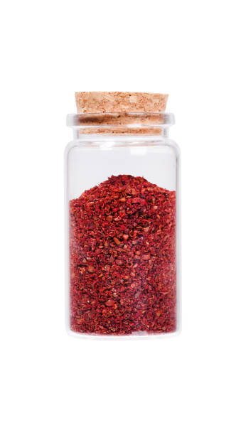 istock Sumac in a glass bottle with cork stopper, isolated on white 1005334978