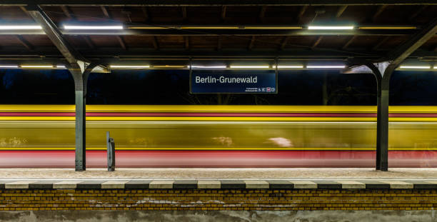 istock Blurred Motion Of Train At Railroad Station Platform 1005339844