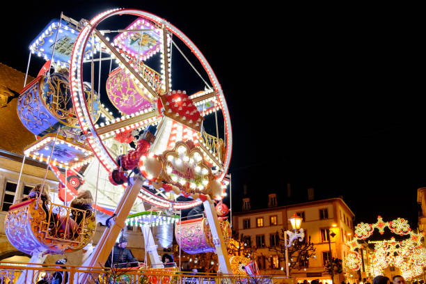 Montbéliard at Christmas (Franche-Comté, France) Children having fun on the ferris wheel in the old town of Montbéliard, where every year a traditional Christmas market is held. Montbéliard is located in the Bourgogne-Franche-Comté region, eastern France. doubs photos stock pictures, royalty-free photos & images