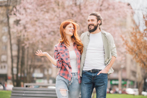 istock Young couple in love walking through the park 1005352282