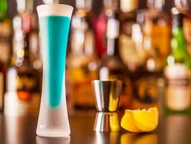 Photo of refreshing liqueur in a tall glass, alcoholic drink prepared by the bartender