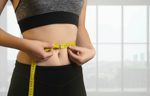 Measuring Her Thin Waist Dieting, Exercising, Women, Waistline, Measuring centimeter photos stock pictures, royalty-free photos & images