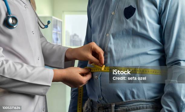 Measuring Overweight Stock Photo - Download Image Now - Overweight, Dieting, Men