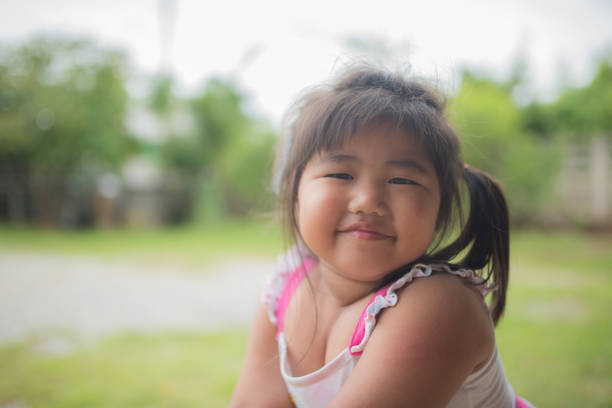 A smile girl with tiny eyes looking at the camera