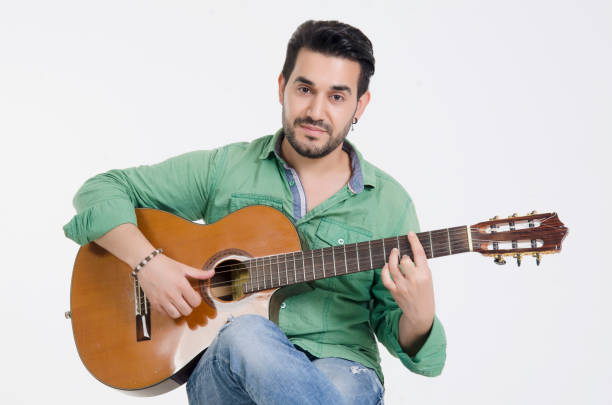 istock young man playing guitar classic guitar 1005378300
