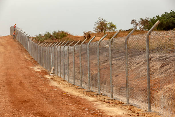 istock Two workers are working on the construction site wire fence at Uganda 1005384404