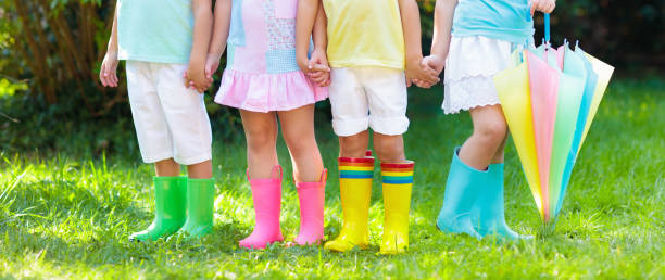 istock Kids in rain boots. Rubber boots for children. 1005384626