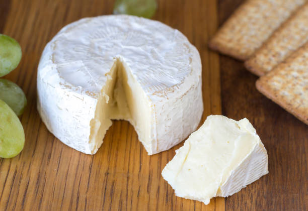 istock Camembert cheese and crackers close up on wooden board 1005384734