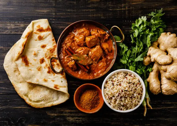 Photo of Chicken tikka masala spicy curry meat food with rice and naan bread