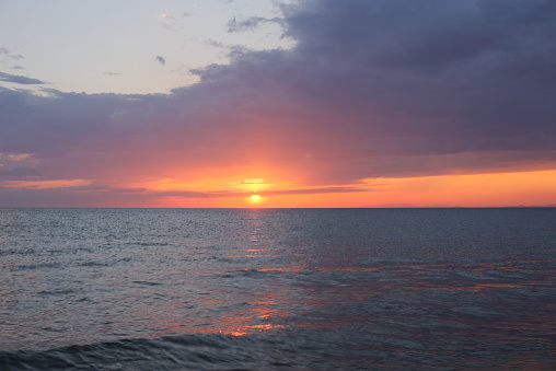 View of beautiful orange sunset over calm sea
