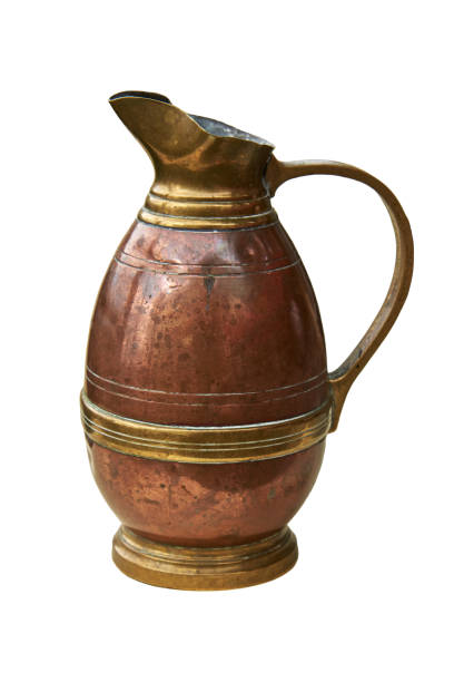 istock An old copper jug for water. Isolated on a white background 1005401676