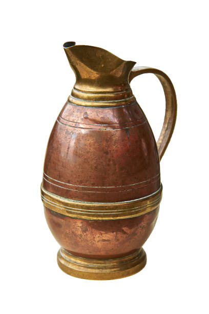 istock An old copper jug for water. Isolated on a white background 1005401764