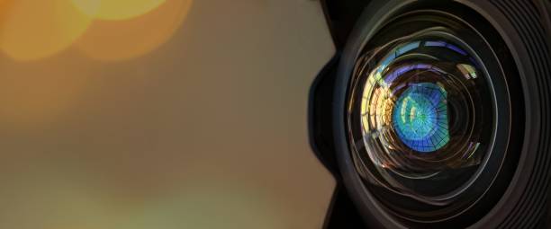 istock Close up of a large camera lens with bokeh background and copy space . 1005402148