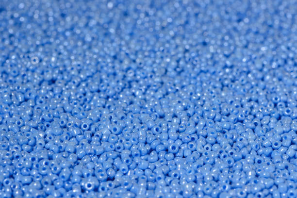istock scattered beads of blue color. 1005418778