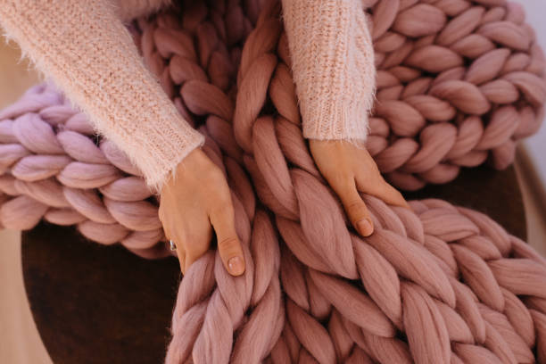 Girl hands holding warm pink blanket