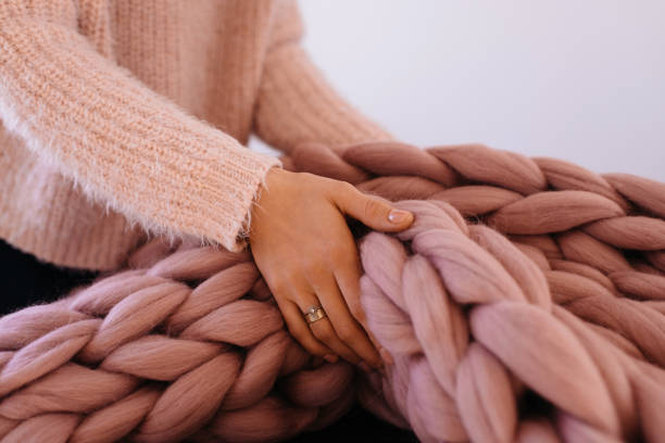 istock Girl hands holding warm pink blanket 1005419100