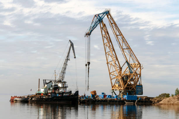 istock Floating cranes loaded goods on the water 1005419618