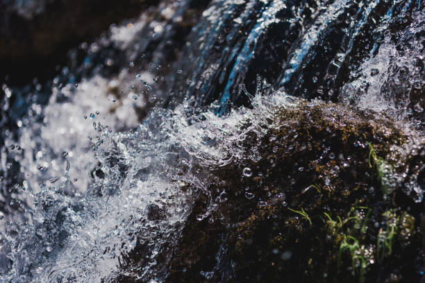 istock selective focus of water flowing with splashes outdoors 1005422236
