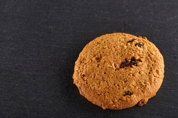 istock Chocolate chips cookies isolated on black background, macro, close-up 1005423434