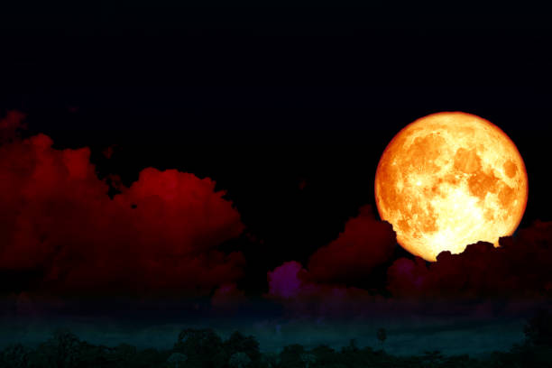istock full strawberry moon back silhouette cloud in night sky 1005432060