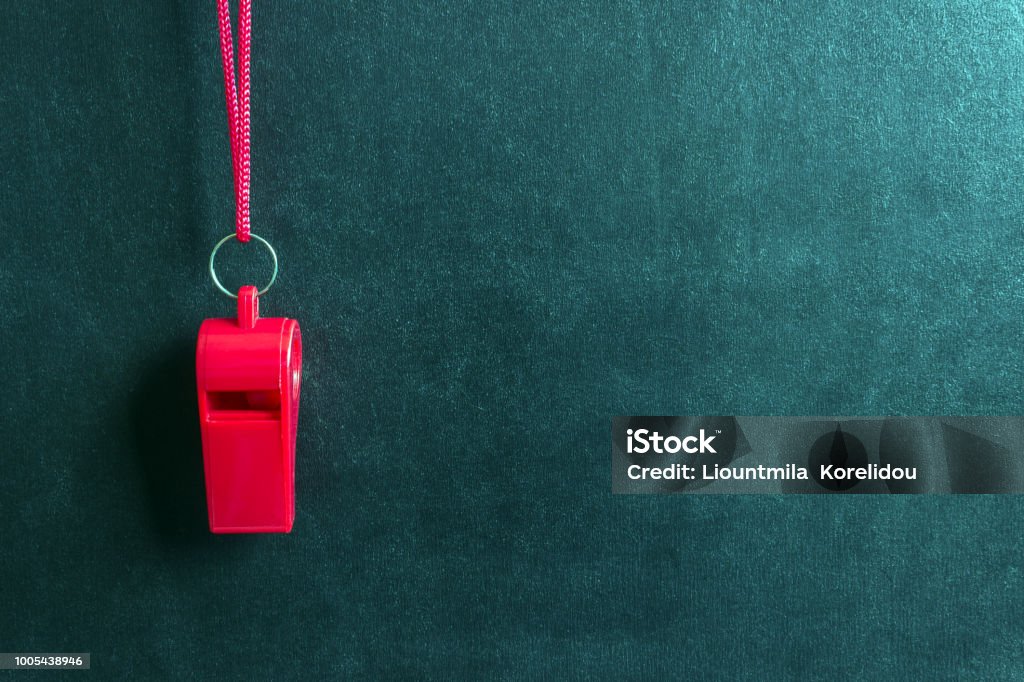 Sports whistle on a red lace.Concept- sport competition, referee, statistics, challenge, friendly match. Sports whistle on a red lace.Concept- sport competition, referee, statistics, challenge, friendly match.Copy space. Rules Stock Photo