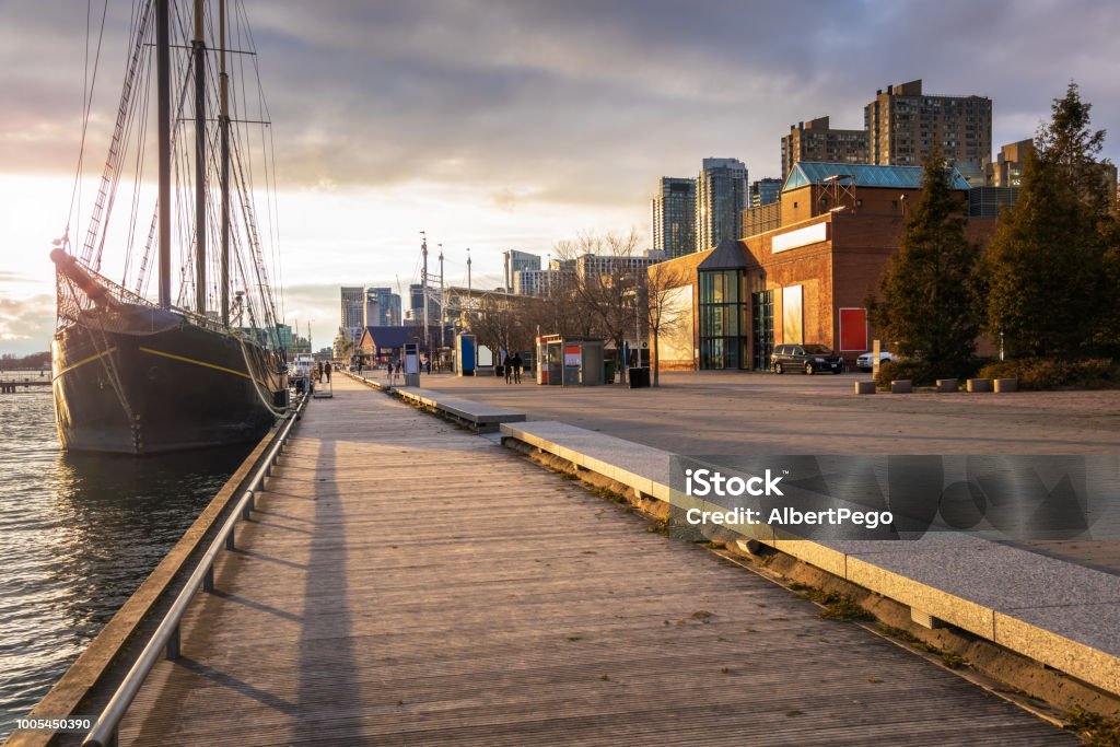 View of Toronto Waterfront at Sunset Boardwalk on Toronto Waterfront Lit by an Autumn Setting Sun. ON, Canada. Toronto Stock Photo