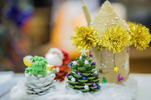 Photo of close up of christmas holiday craft supplies and hand made christmas trees