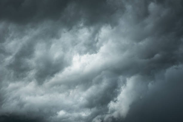 istock Black cloud and thunderstorm before rainy, Dramatic  black clouds and dark sky 1005462468