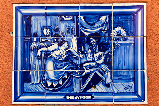 Fado, picturesque Azulejo on the outside wall of a house in Alfama district, Lisbon, Portugal