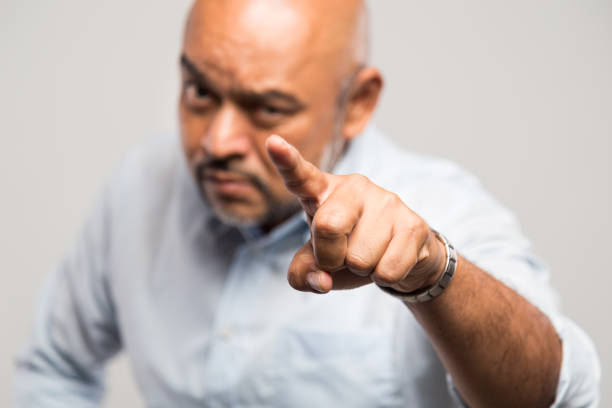 istock Focus on finger of angry man with aggressive facial expression 1005466092
