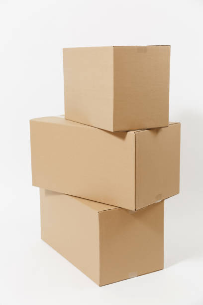 istock Stacked of three brown clear empty blank cardboard boxes isolated on white background. Receiving package. Copy space for advertisement. With place for text. Advertising area with workspace. 1005483096