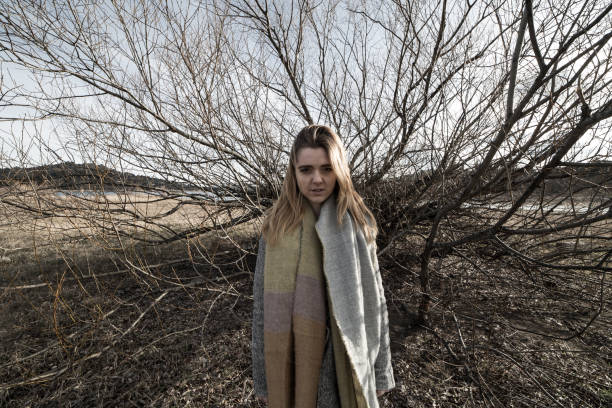 istock Young woman under the dark shadow of a tree with many branches 1005483464