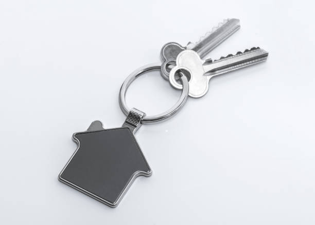 istock House Key And Key chain On white background 1005484304